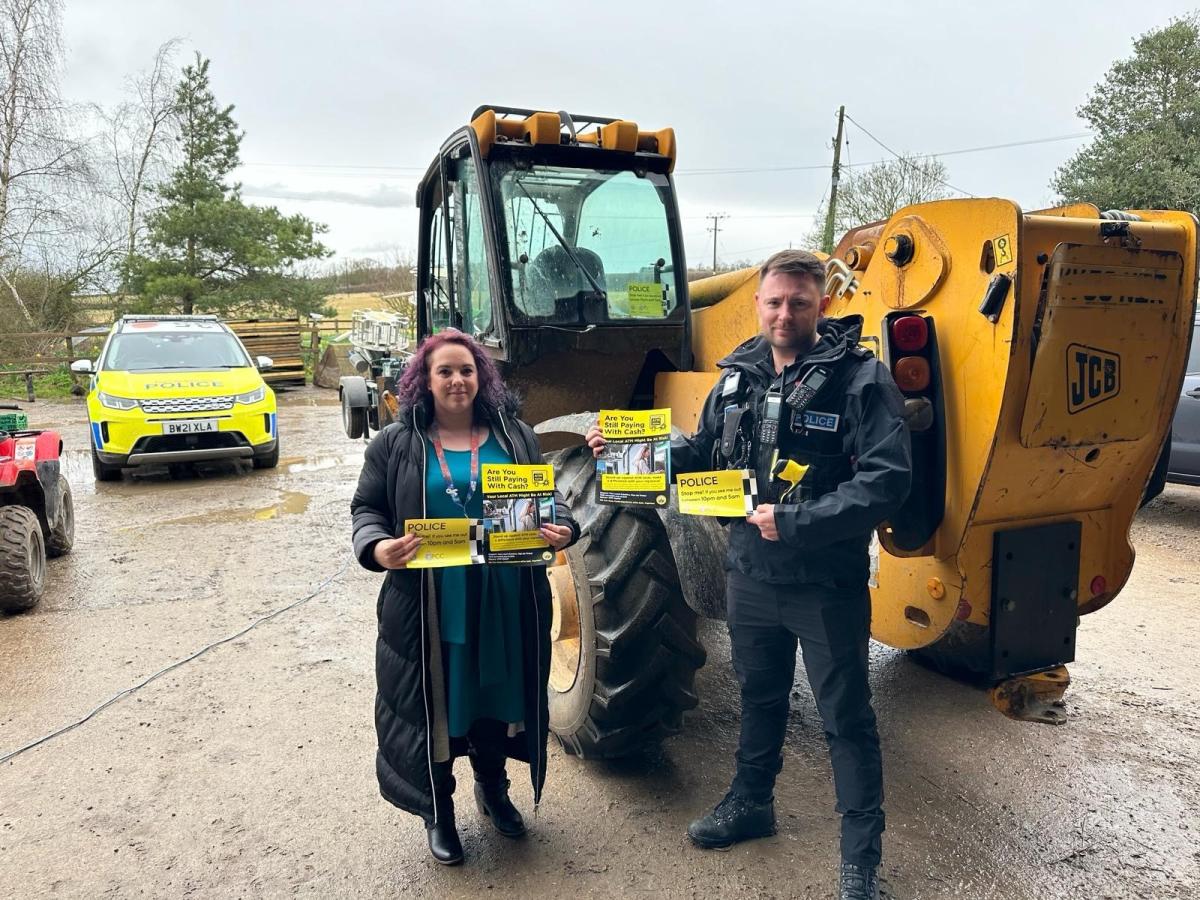 Jo Johnson Andow is pictured with Sgt Tom Nuttall holding "Stop Me" stickers in front of a tractor