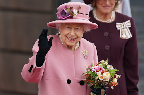 The Queen smiling and waving